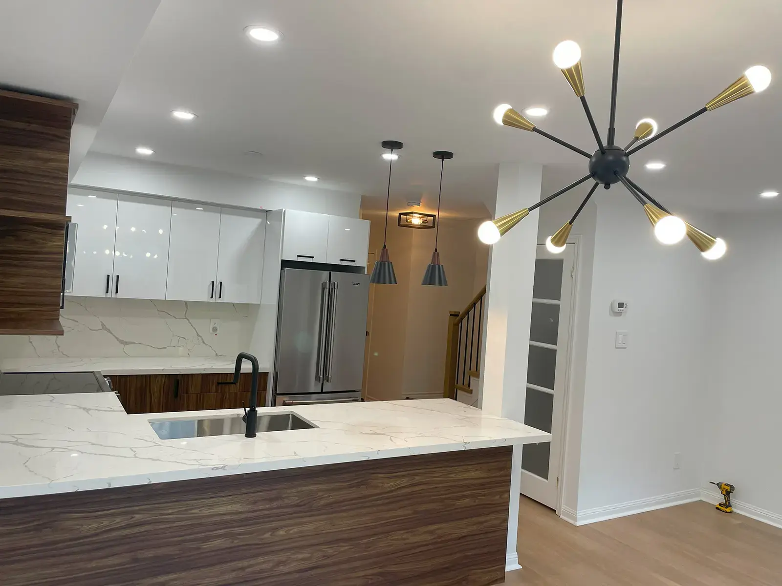 Kitchen and dining area with a starburst chandelier — 556 Bondi Ave, Newmarket