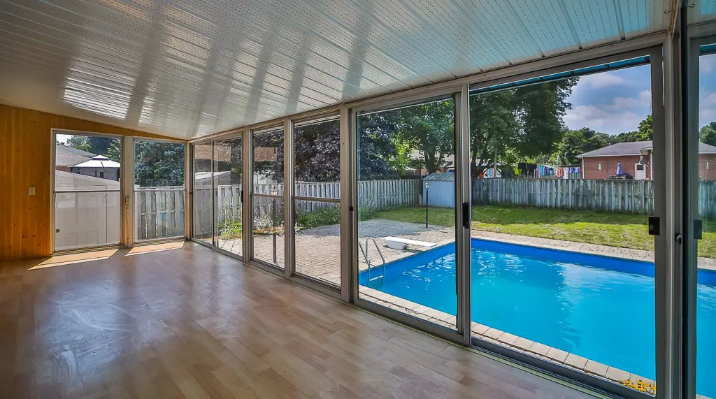 Sunroom with sliding glass walls overlooking the pool — 41 Springhome, Barrie